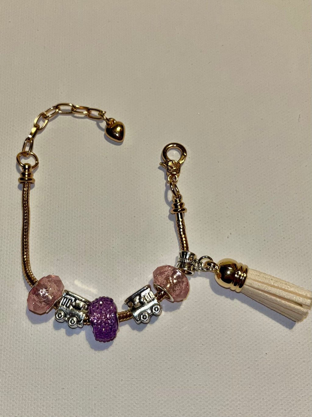 Gold-Tone Snake Chain Bracelet w/Pink & Purple Beads, Cream Tassel & Train Charm