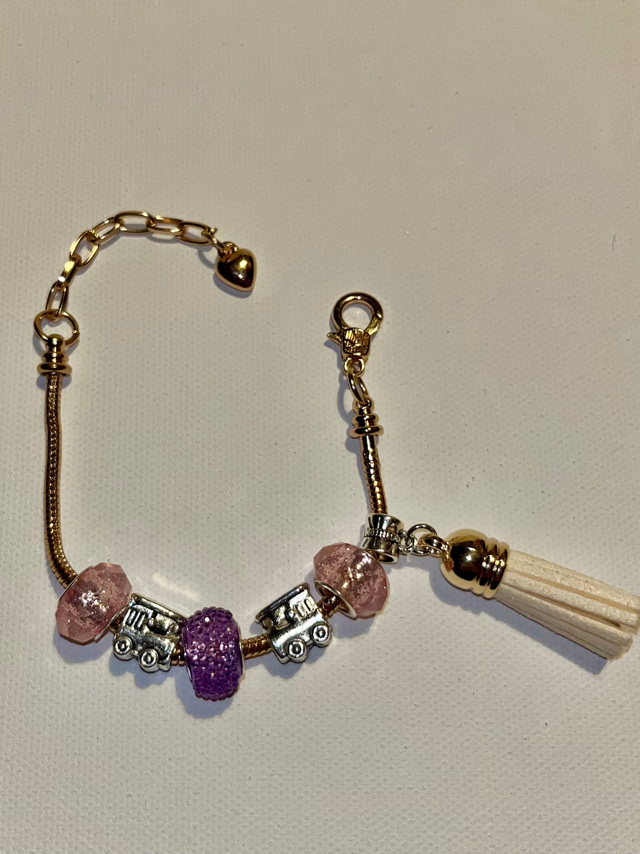 Gold-Tone Snake Chain Bracelet w/Pink & Purple Beads, Cream Tassel & Train Charm