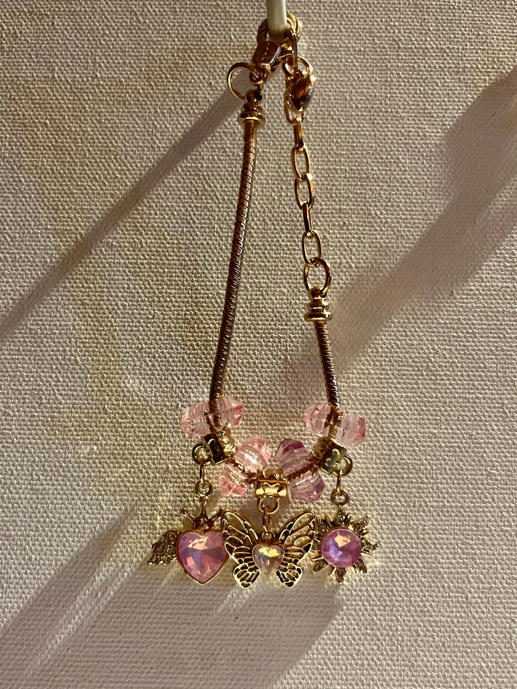 Gold-Tone Pink Crystal Charm Bracelet with Butterfly, Heart & Sun Charms