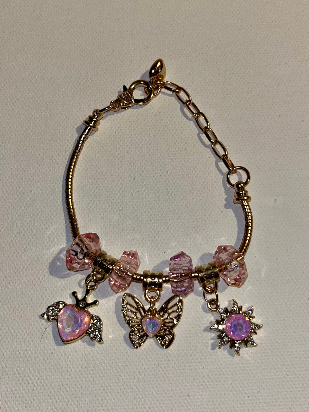 Gold-Tone Pink Crystal Charm Bracelet with Butterfly, Heart & Sun Charms