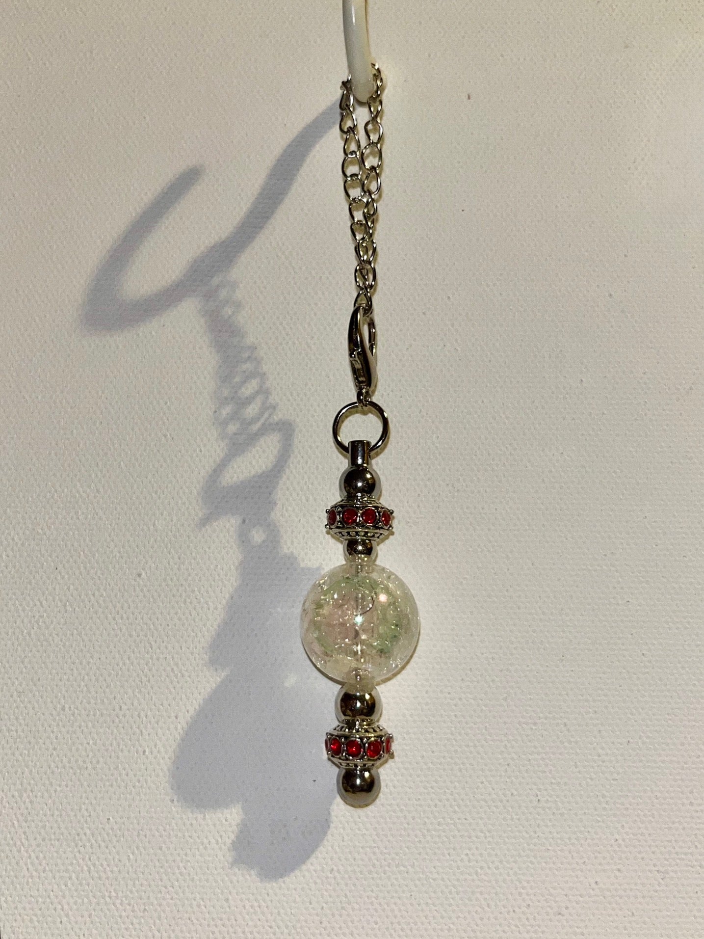 Cracked Iridescent Crystal Globe Keychain with Red Rhinestone Accent Detailing