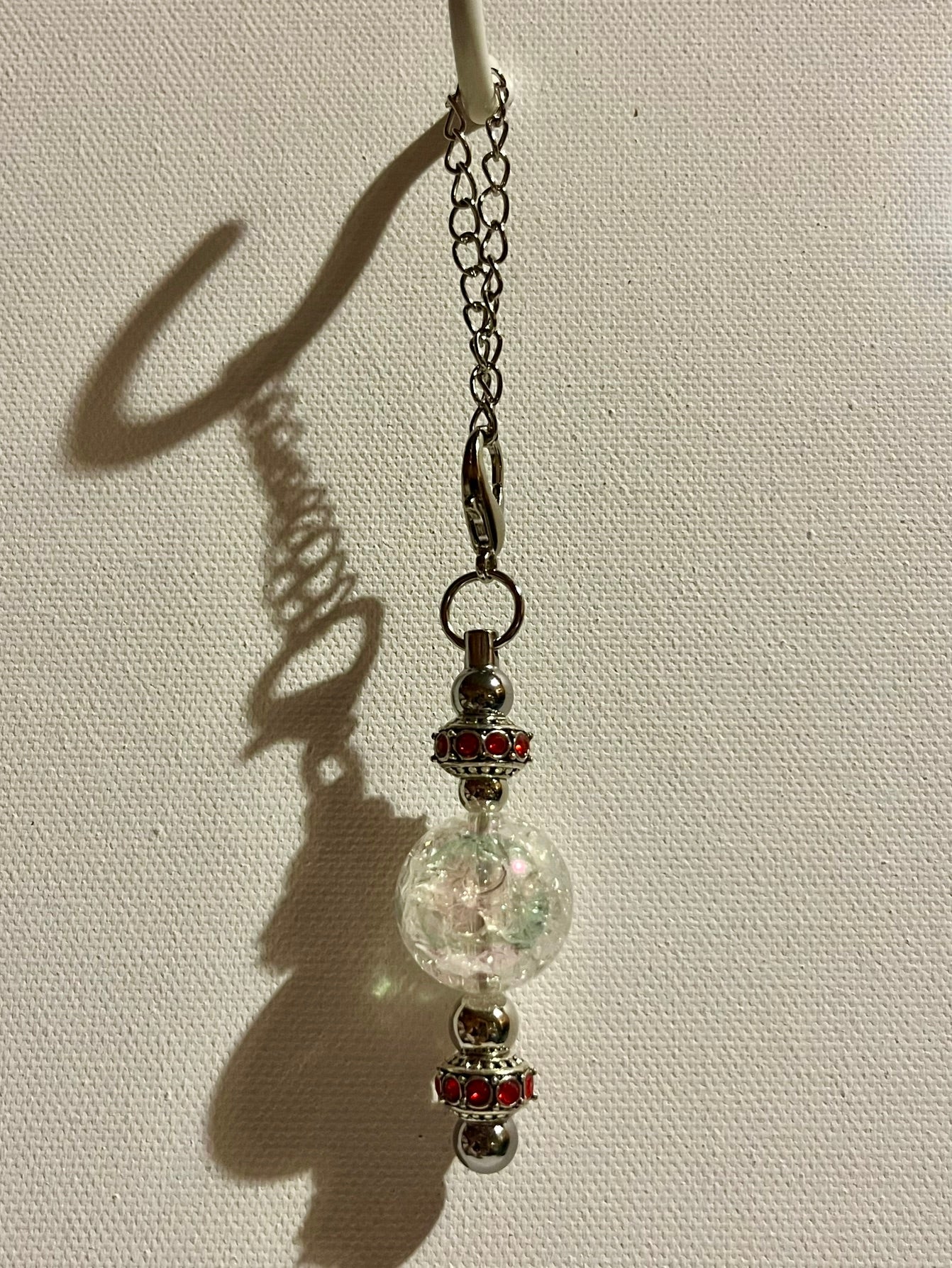 Cracked Iridescent Crystal Globe Keychain with Red Rhinestone Accent Detailing