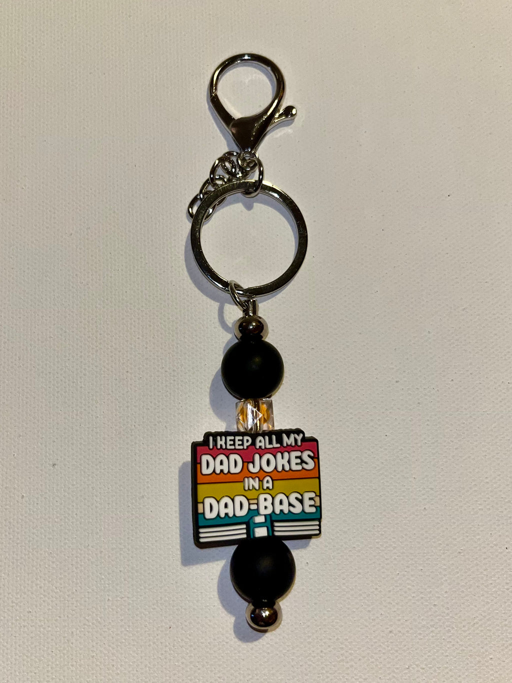 ‘I Keep All My Jokes in a Dad-Base’ Black with Retro Stripes Keychain